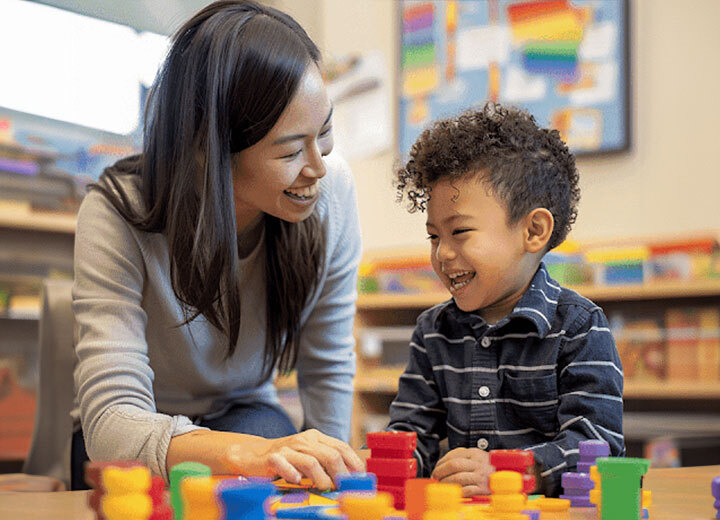 Therapist and child enjoying ABA therapy session with educational toys