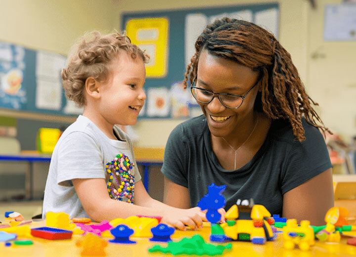 ABA therapist and child engaging in a learning activity with colorful toys