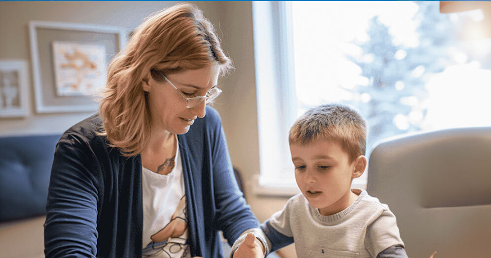 ABA therapist using flashcards with a child during a therapy session