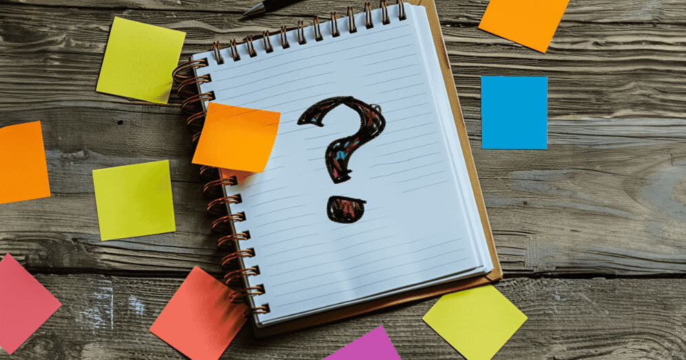 Notebook with question mark and sticky notes for ABA therapy FAQs